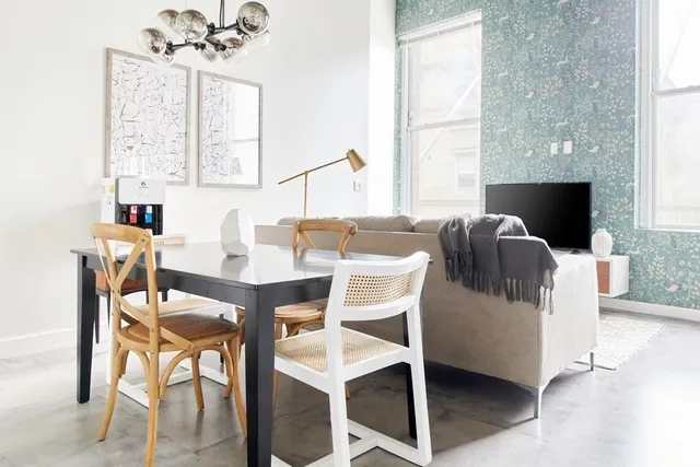 a dining room with furniture and window