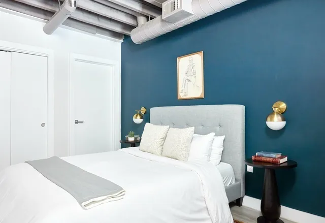 a bedroom with a bed and a table