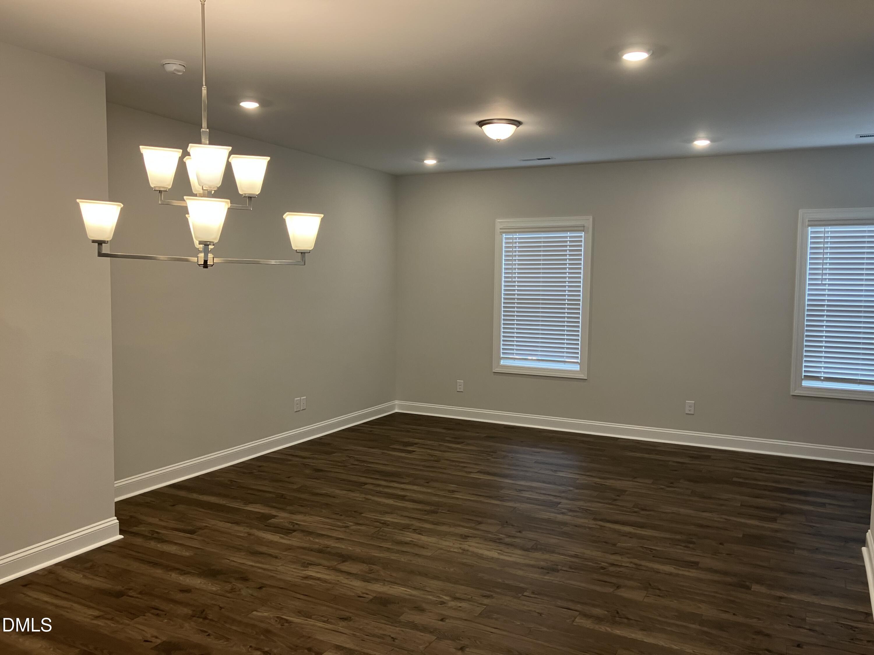 2042 Fishamble Street Fuquay-Varina, NC 27526 - Photo 5 of 15 a view of a room with wooden floor and chandelier
