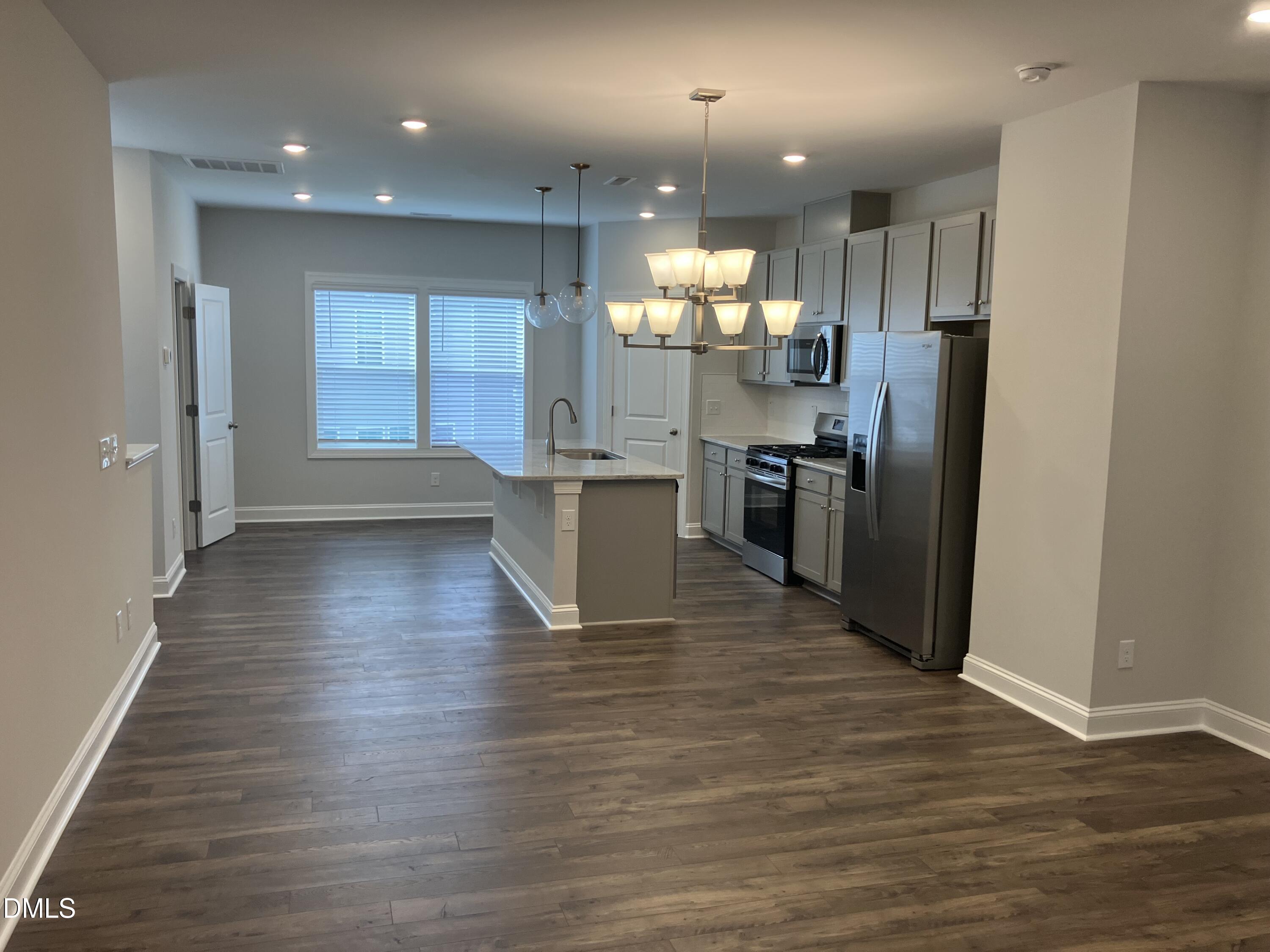 2042 Fishamble Street Fuquay-Varina, NC 27526 - Photo 6 of 15 a kitchen with stainless steel appliances granite countertop a refrigerator and a stove top oven