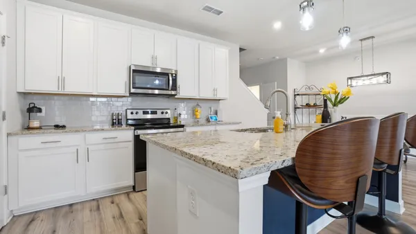 a kitchen with stainless steel appliances granite countertop a sink dishwasher and cabinets with wooden floor