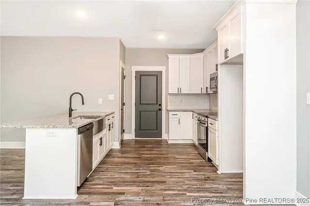 a kitchen with a sink and a refrigerator