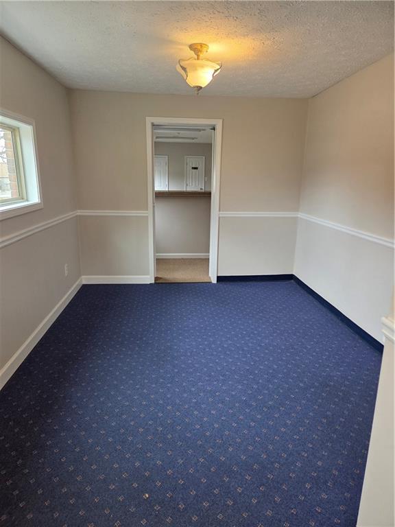 293 North Broad Street Winder, GA 30680 - Photo 6 of 10 an empty room with a fireplace and windows