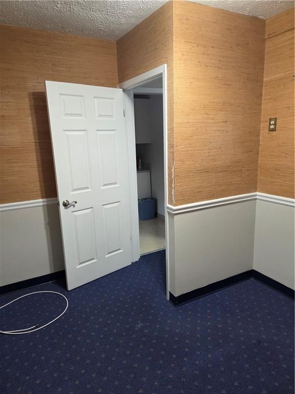 293 North Broad Street Winder, GA 30680 - Photo 7 of 10 an empty room with wooden floor and cabinet