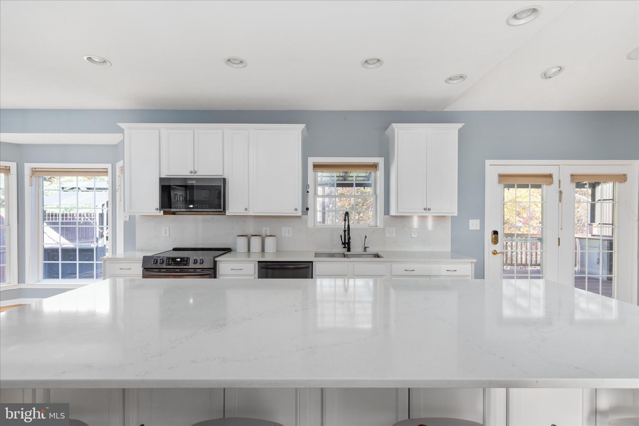 1286 Three Run Road Inwood, WV 25428 - Photo 14 of 74 a kitchen with stainless steel appliances granite countertop a sink a stove and white cabinets