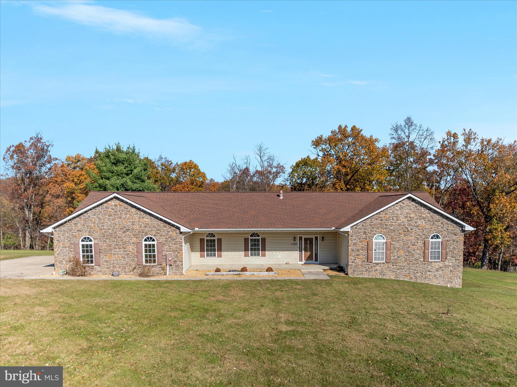 1286 Three Run Road Inwood, WV 25428 - Photo 2 of 74 a front view of house with yard and trees in the background