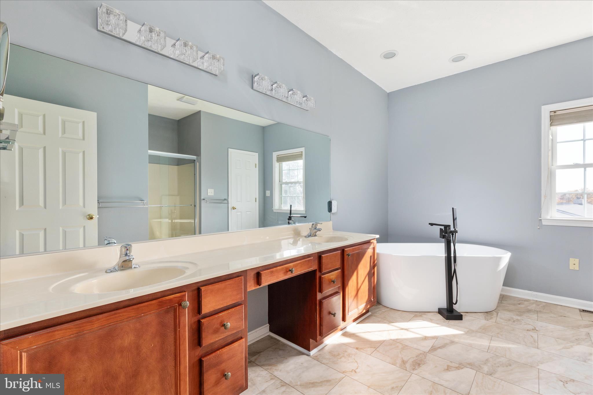 1286 Three Run Road Inwood, WV 25428 - Photo 23 of 74 a spacious bathroom with a double vanity sink mirror and bathtub