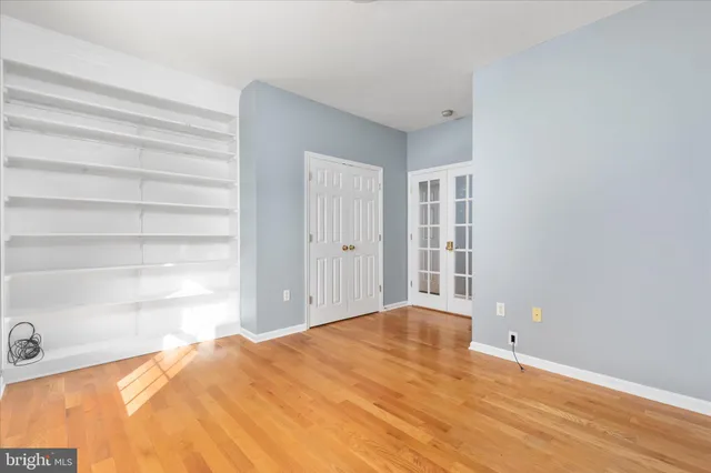 a kitchen with stainless steel appliances granite countertop a refrigerator sink and white cabinets