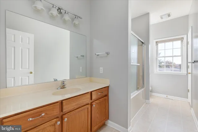 a kitchen with cabinets appliances a sink and a counter top space