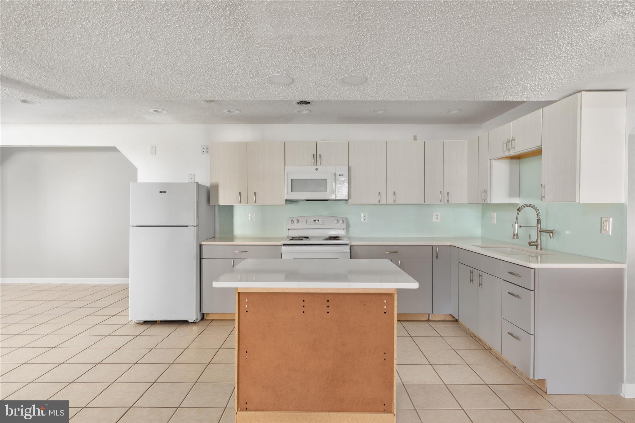 1286 Three Run Road Inwood, WV 25428 - Photo 35 of 74 a kitchen with stainless steel appliances granite countertop a refrigerator sink and white cabinets