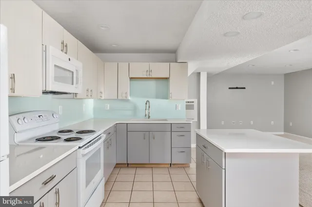 a bathroom with a granite countertop sink a large mirror and a toilet