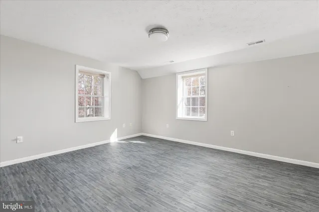 a front view of a house with a garden and yard