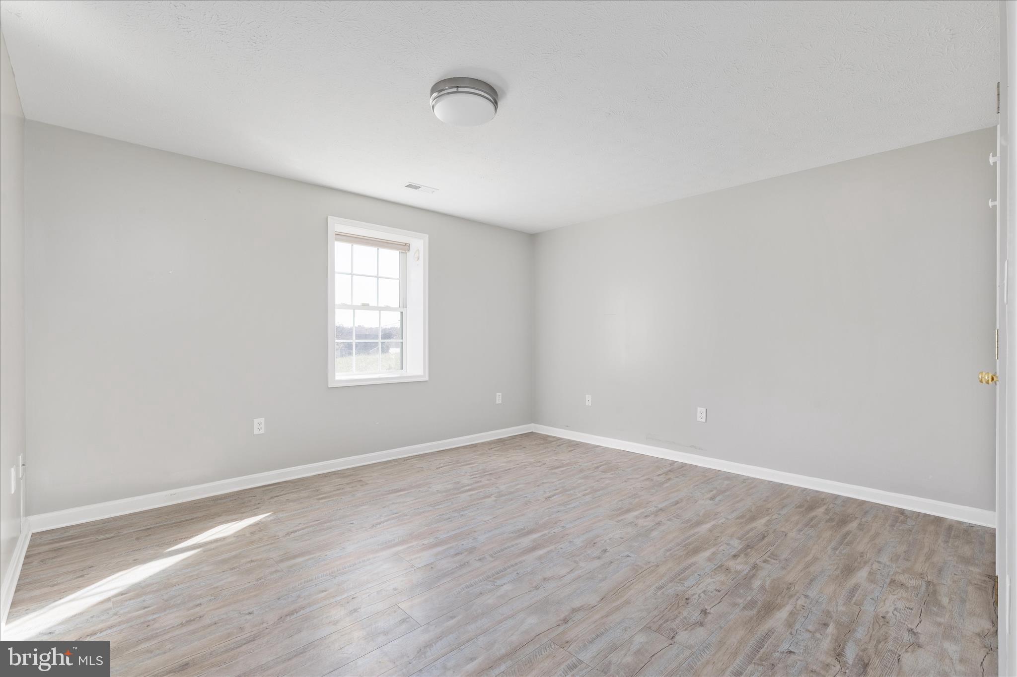 1286 Three Run Road Inwood, WV 25428 - Photo 41 of 74 a view of an empty room with wooden floor and a window