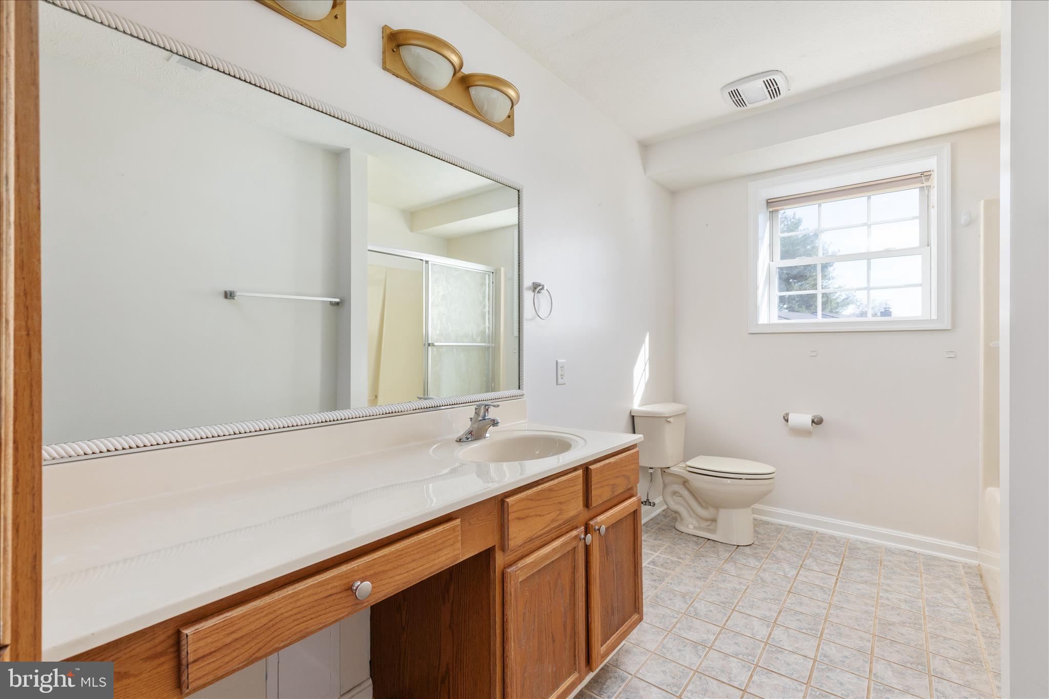 1286 Three Run Road Inwood, WV 25428 - Photo 42 of 74 a bathroom with a granite countertop sink a large mirror and a toilet