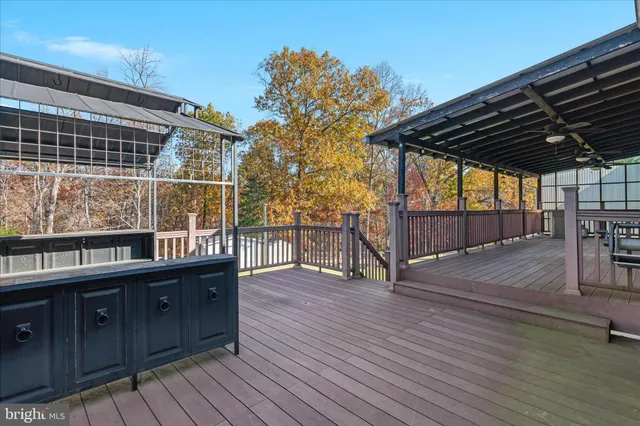an aerial view of a house with a garden and lake view