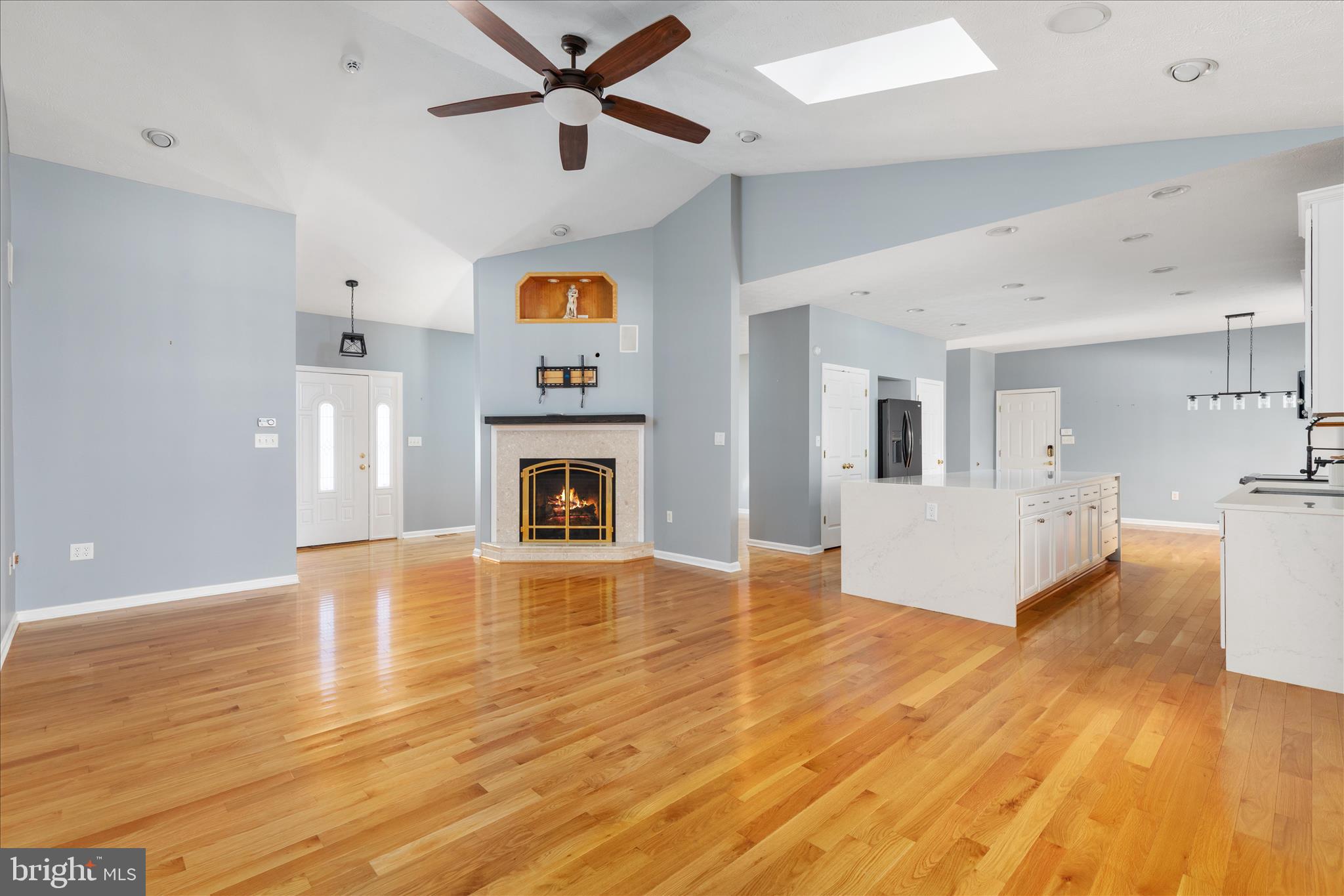 1286 Three Run Road Inwood, WV 25428 - Photo 5 of 74 a view of a livingroom with a fireplace a ceiling fan and wooden floor