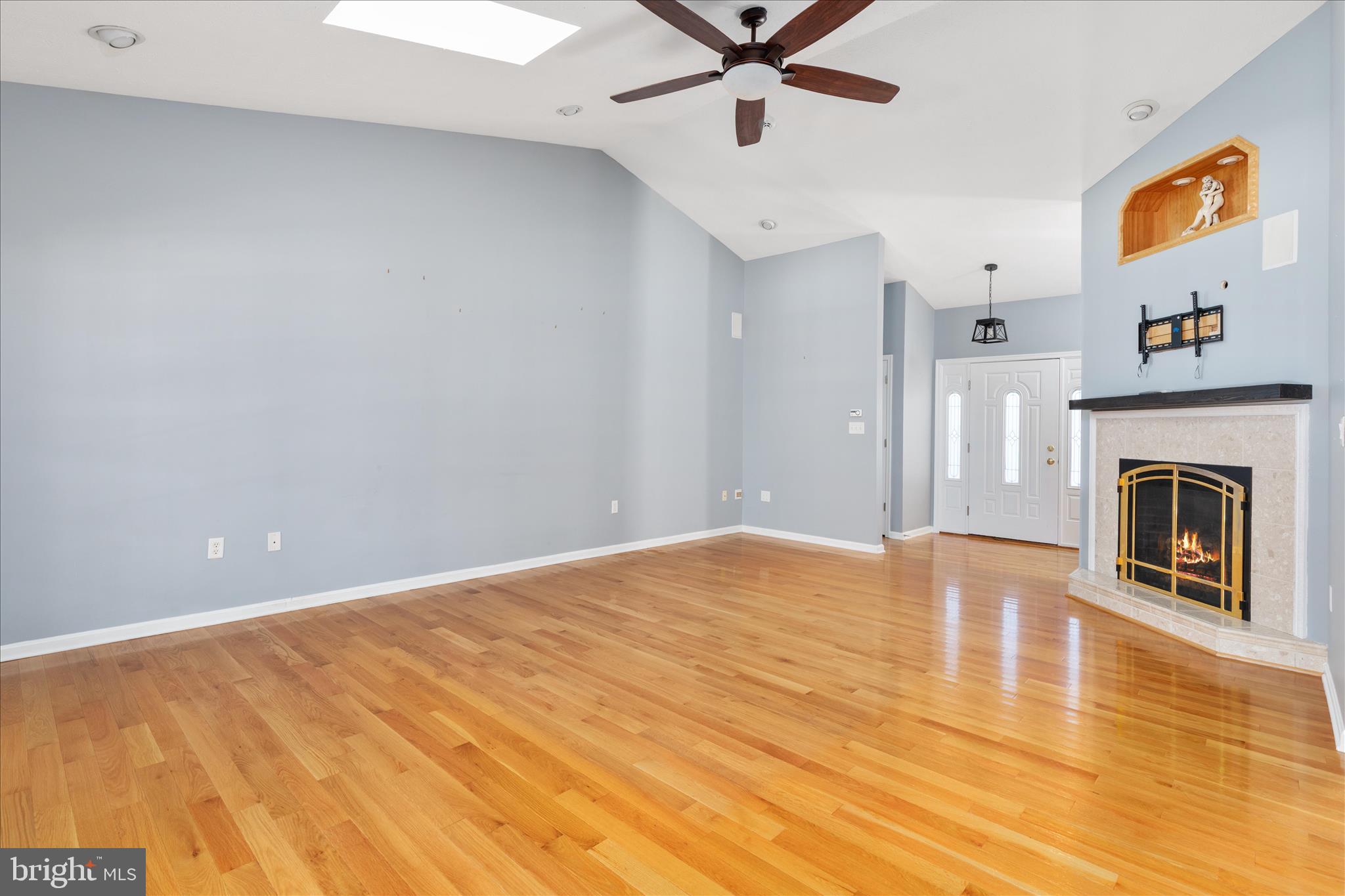 1286 Three Run Road Inwood, WV 25428 - Photo 6 of 74 a view of a livingroom with a fireplace a ceiling fan and kitchen view