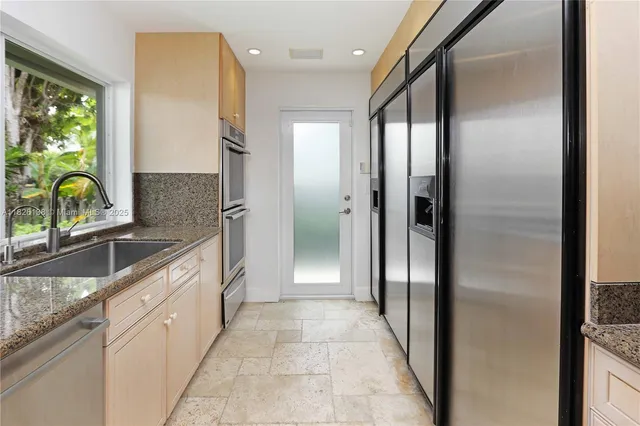 a spacious bedroom with a large bed and a chandelier