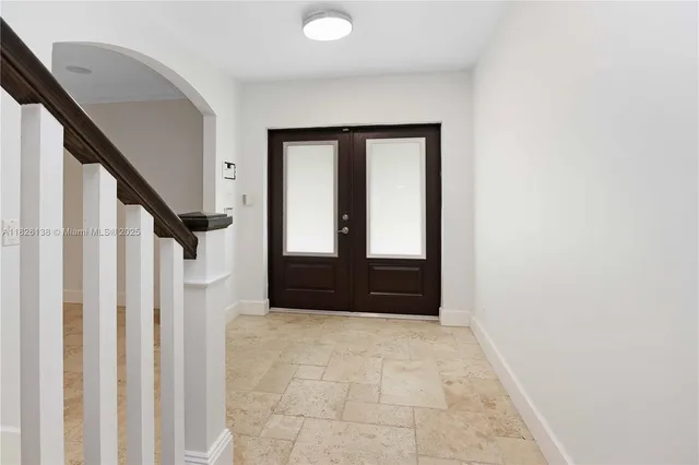a bedroom with bed and glass door