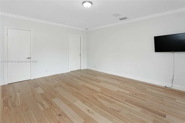 a living room with furniture a table and a bookshelf