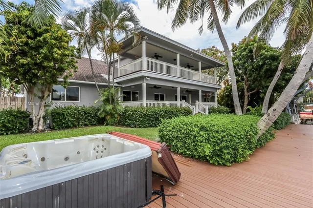 an aerial view of a house yard swimming pool and outdoor seating