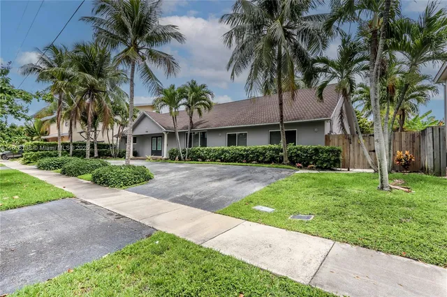 a view of house with yard and lake