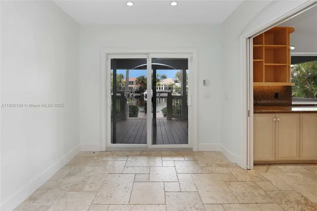 a large kitchen with kitchen island granite countertop a large counter top and wooden cabinets