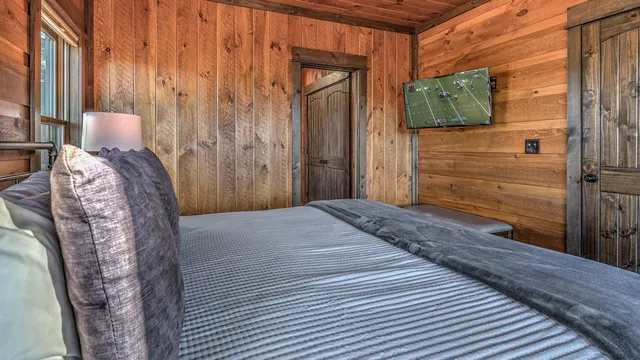 a balcony with wooden floor table and chairs