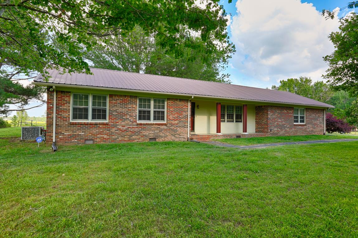 52 Power Station Road Taft, TN 38488 - Photo 1 of 30 a front view of a house with a garden