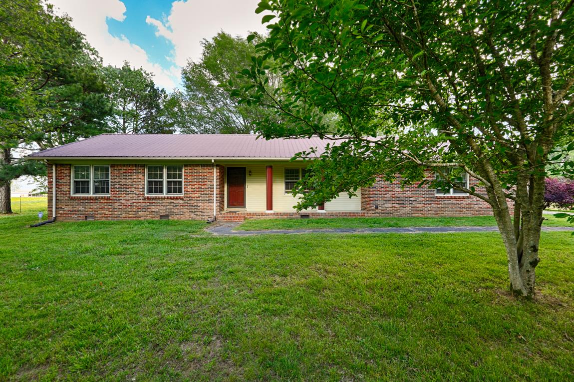 52 Power Station Road Taft, TN 38488 - Photo 3 of 30 a front view of a house with a garden