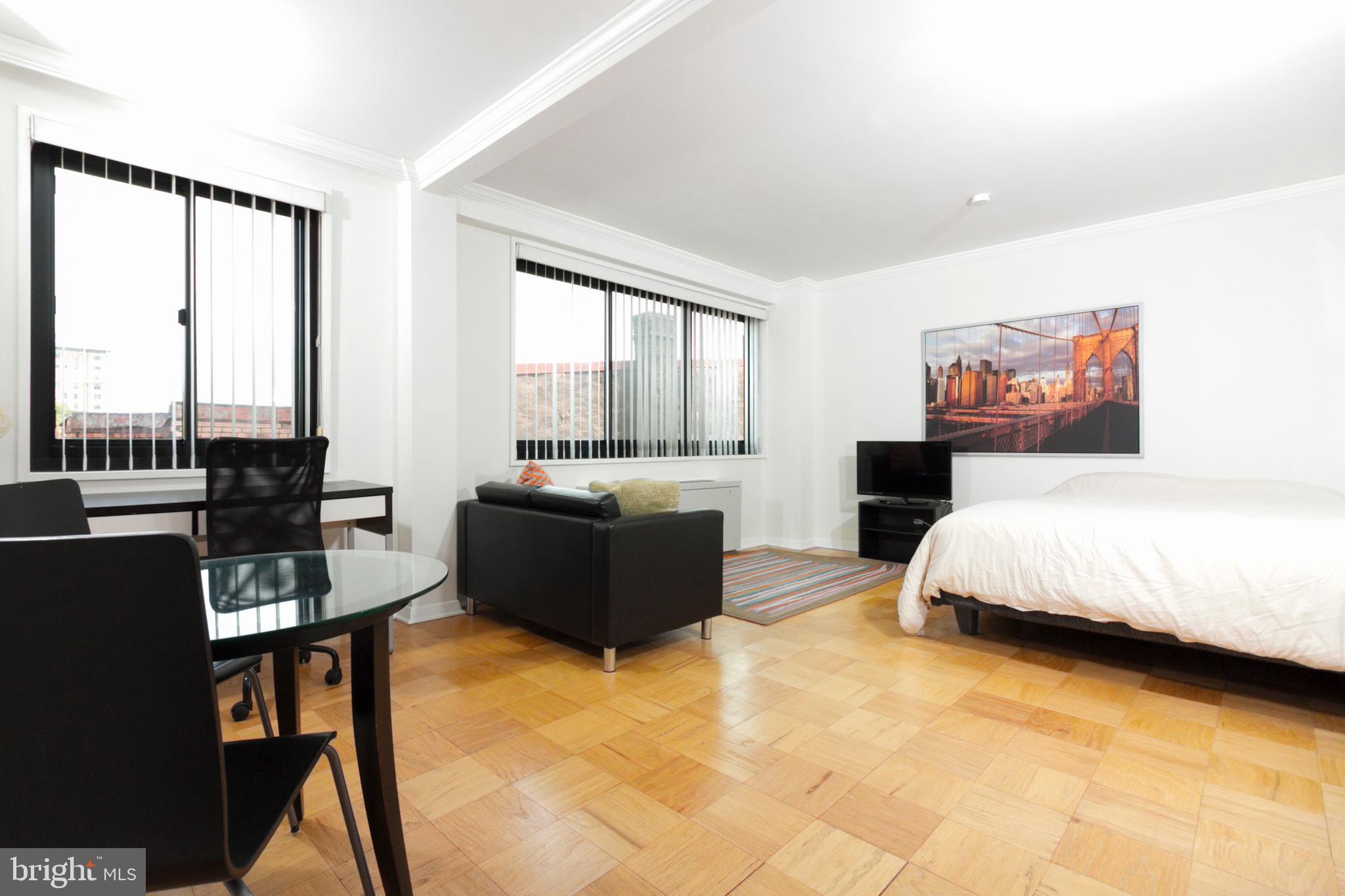 1601 18th Street Northwest, Unit 508 Washington, DC 20009 - Photo 14 of 31 a bedroom with a bed and a couch