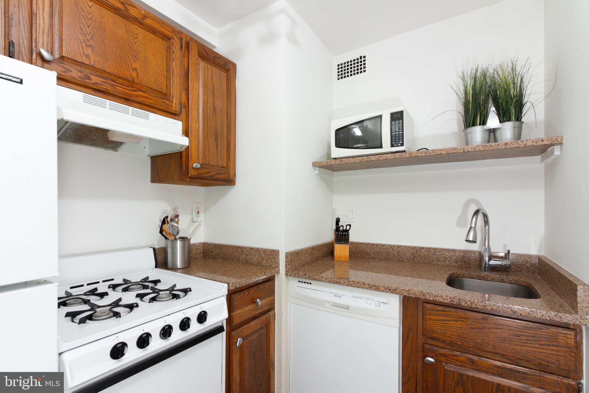 1601 18th Street Northwest, Unit 508 Washington, DC 20009 - Photo 19 of 31 a kitchen with stainless steel appliances a sink a stove and cabinets