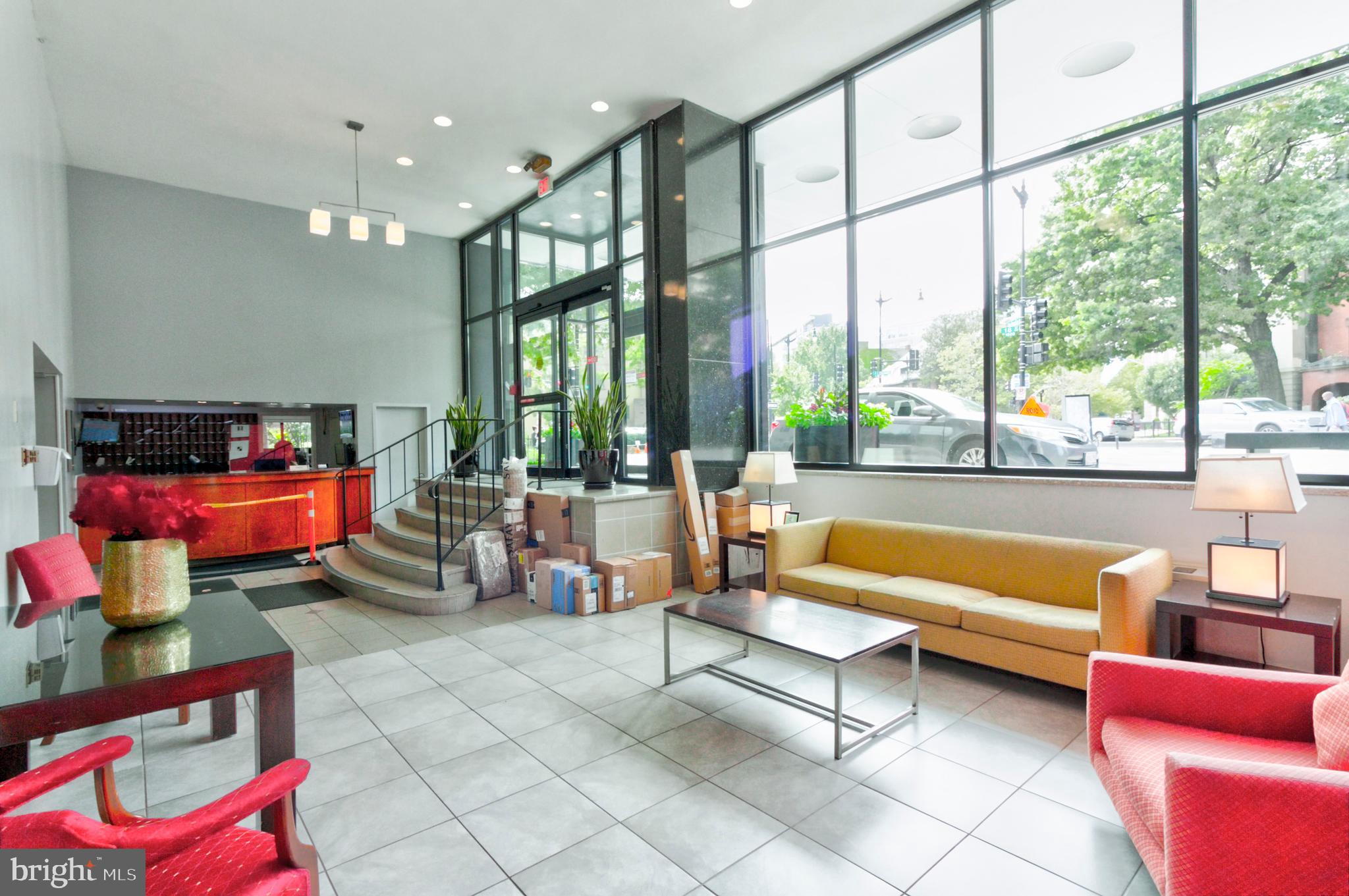 1601 18th Street Northwest, Unit 508 Washington, DC 20009 - Photo 5 of 31 a living room with furniture and a floor to ceiling window