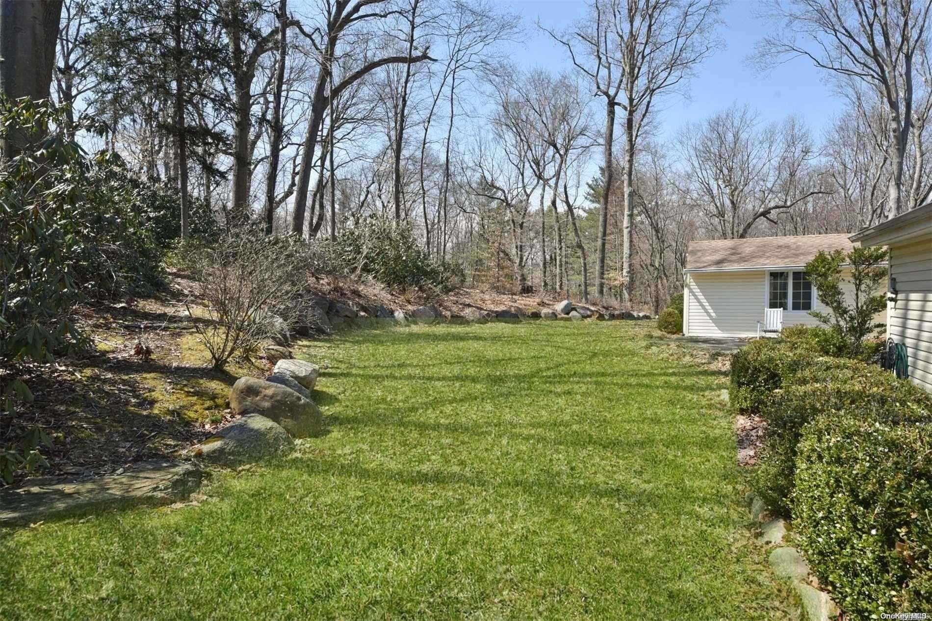 1 Parish Drive Locust Valley, NY 11560 - Photo 16 of 19 a backyard of a house with lots of green space