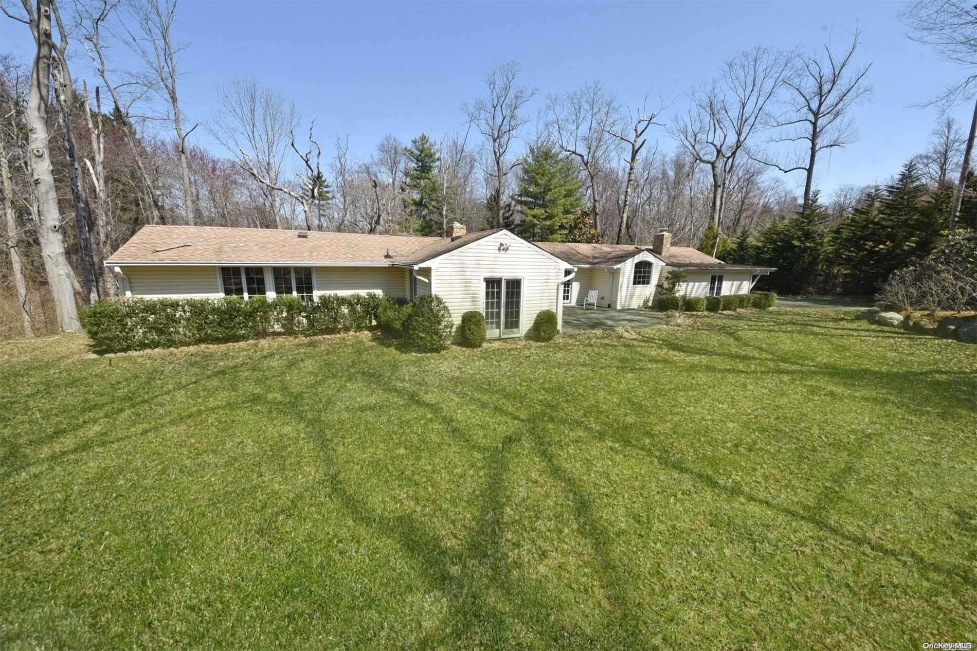 1 Parish Drive Locust Valley, NY 11560 - Photo 17 of 19 a front view of a house with a yard