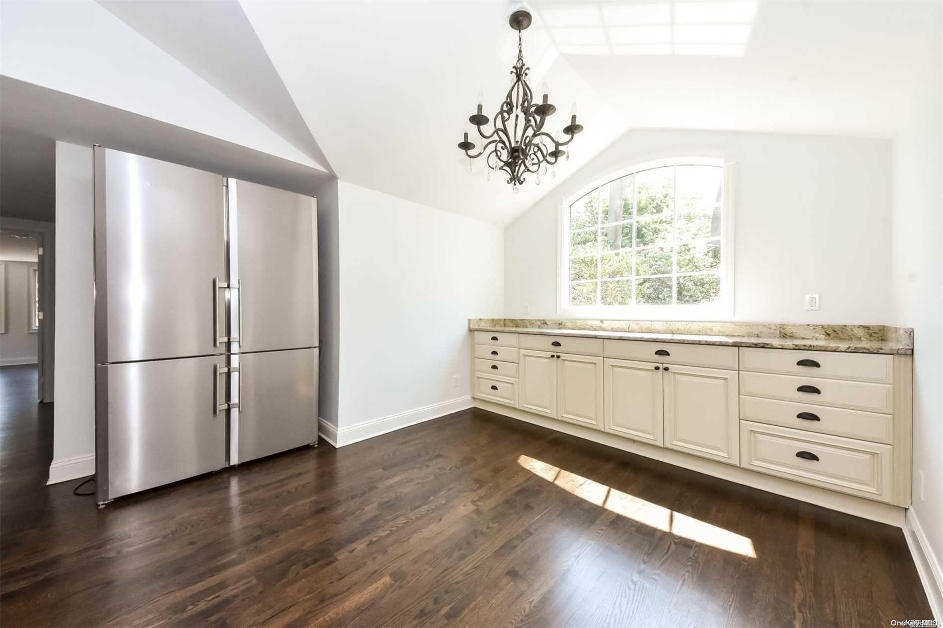 1 Parish Drive Locust Valley, NY 11560 - Photo 5 of 19 a kitchen with a refrigerator and chandelier