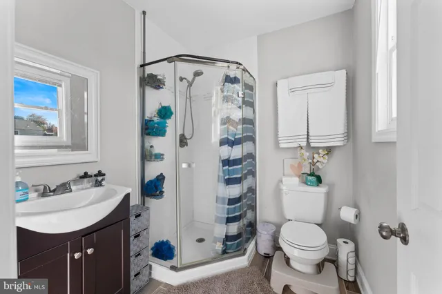 a bathroom with a sink toilet and shower