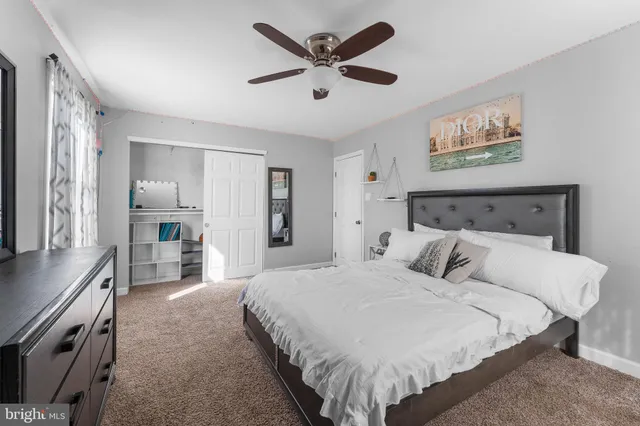 a bedroom with a large bed and a chandelier