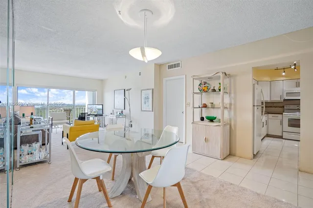 a view of a dining room with furniture and a chandelier