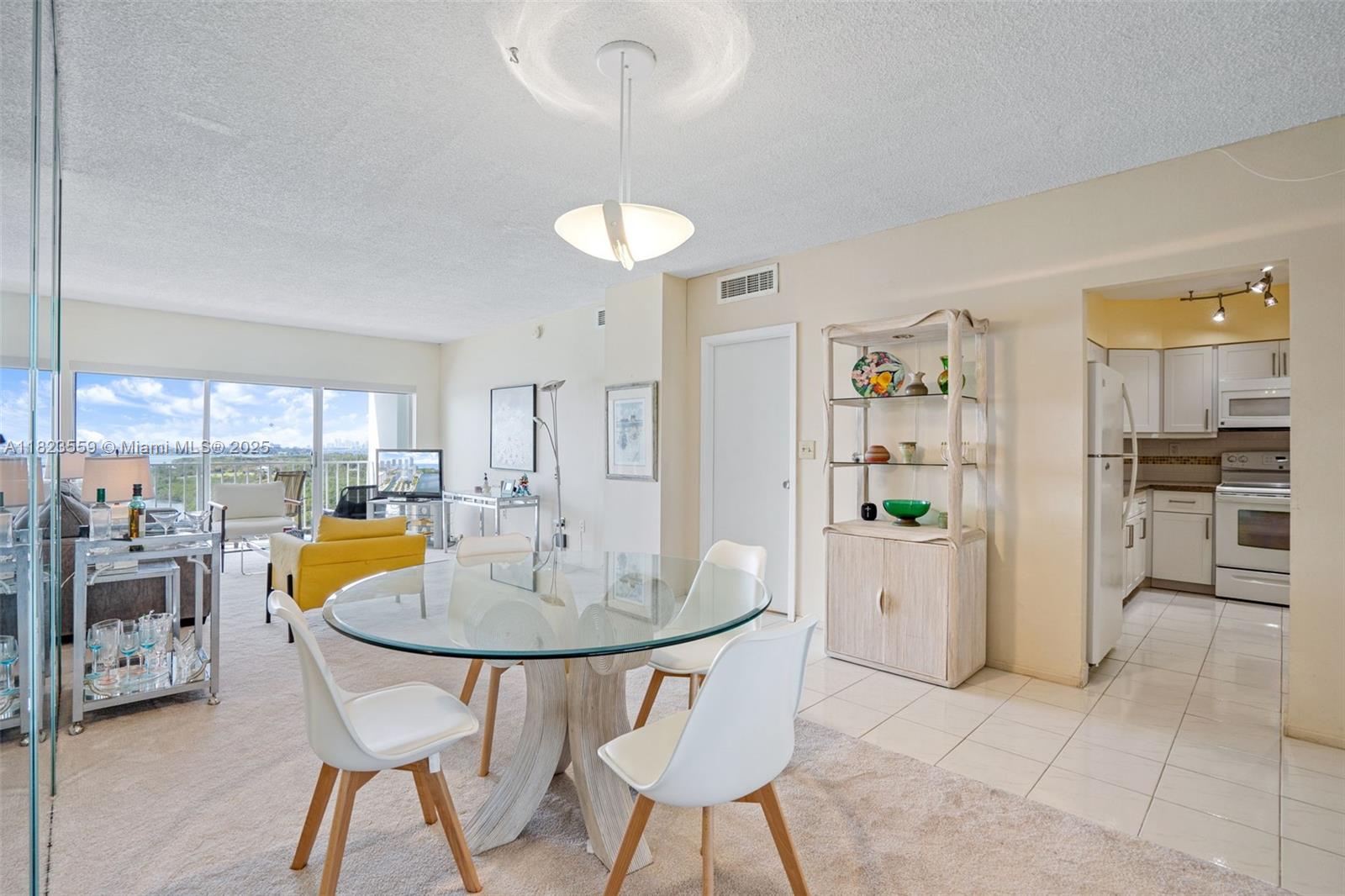 500 Bayview Drive, Unit 228 Sunny Isles Beach, FL 33160 - Photo 11 of 18 a view of a dining room with furniture and a chandelier