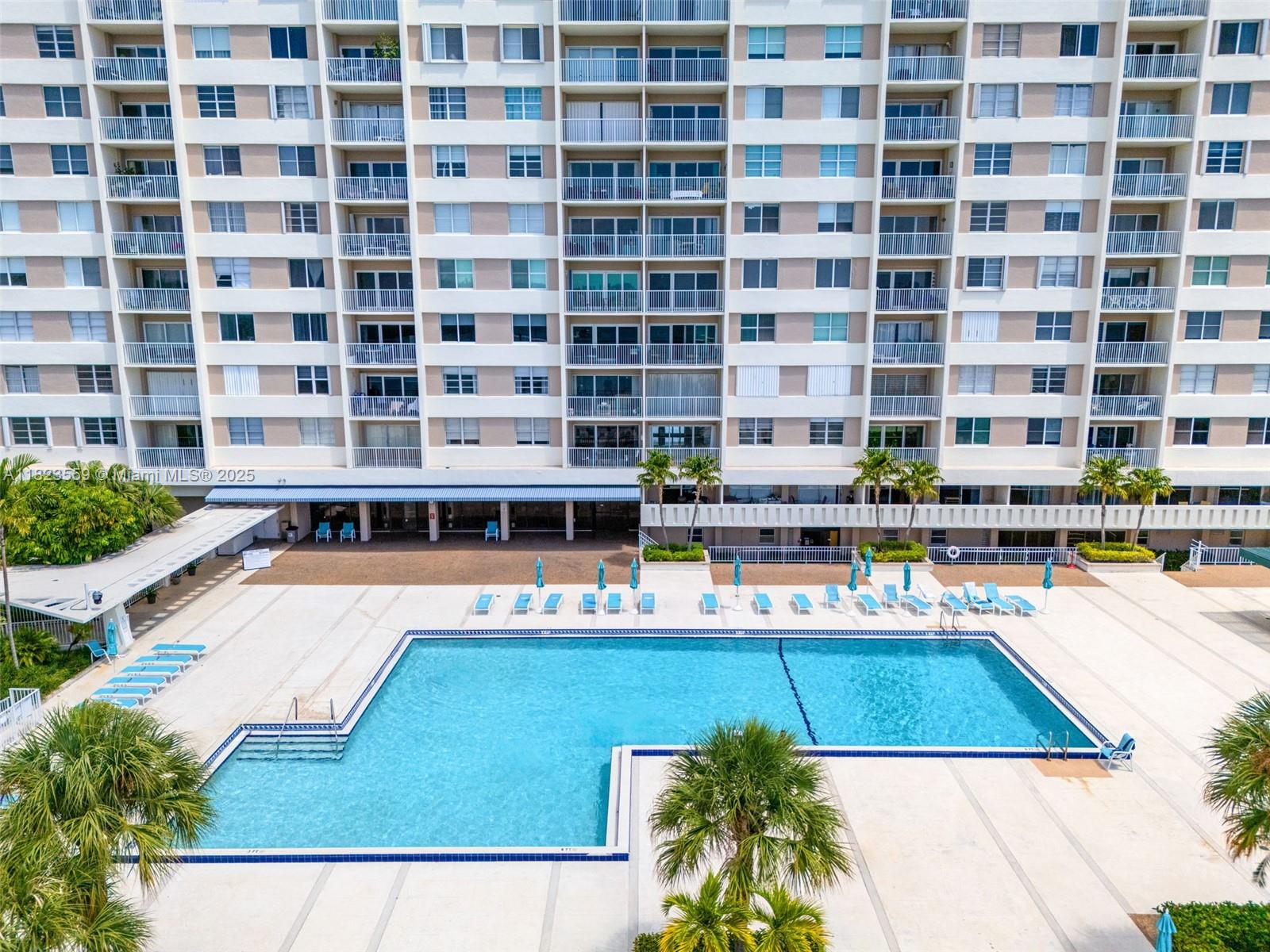 500 Bayview Drive, Unit 228 Sunny Isles Beach, FL 33160 - Photo 16 of 18 a view of a swimming pool with outdoor seating