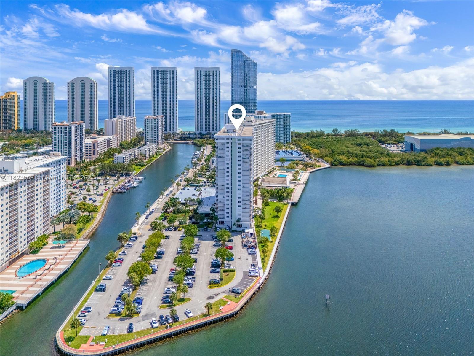 500 Bayview Drive, Unit 228 Sunny Isles Beach, FL 33160 - Photo 2 of 18 a swimming pool with outdoor seating and yard