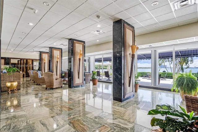 a lobby with furniture and floor to ceiling window