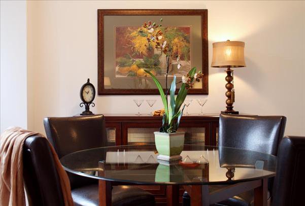 Undisclosed Address Manhattan, NY 10022 - Photo 9 of 14 a table with a vase and flowers on it
