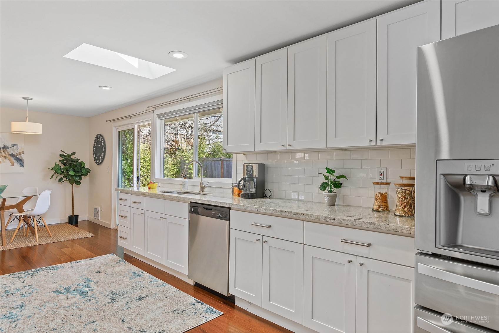 22605 13th Place West Bothell, WA 98021 - Photo 12 of 33 a kitchen with granite countertop white cabinets white appliances a sink and a window