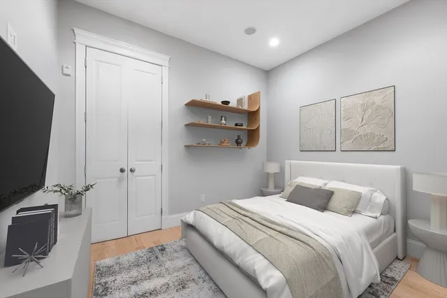 a bedroom with a bed and a flat screen tv