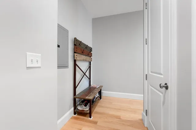 a view of room with wooden floor and bathroom