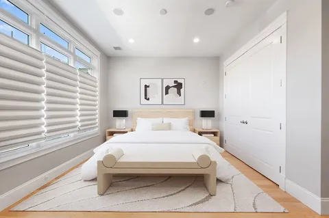 a bedroom with a large bed and a window