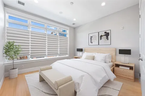 a spacious bedroom with a large bed and a couch