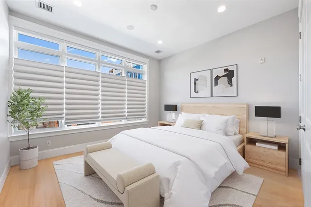 a spacious bedroom with a large bed and a couch